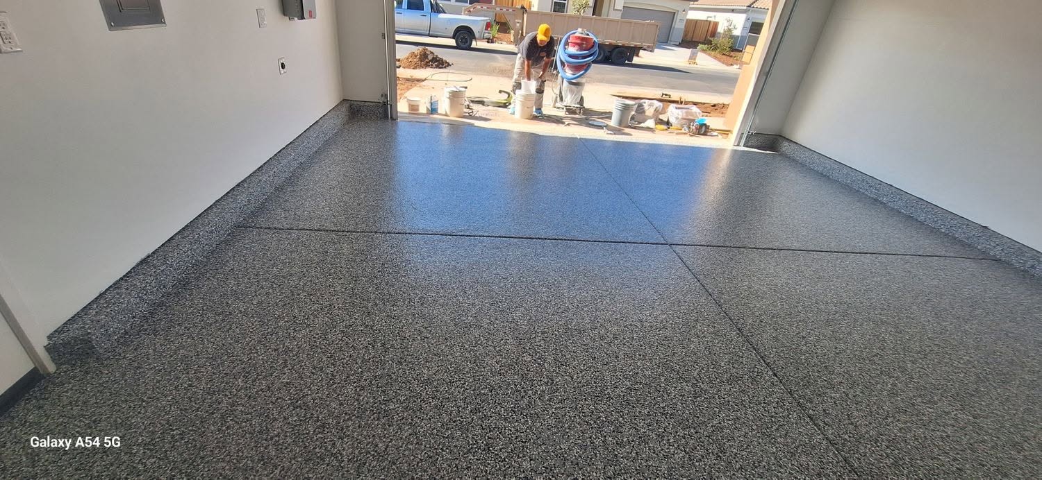 Dark flake epoxy floor in newly finished garage