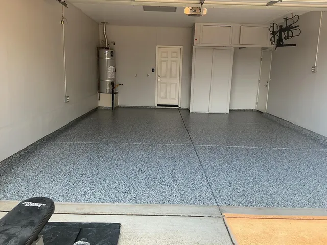 Blue-gray flake epoxy floor in empty garage